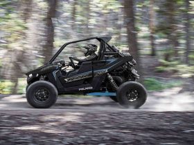 Polaris RZR RS1 driving fast in the forrest