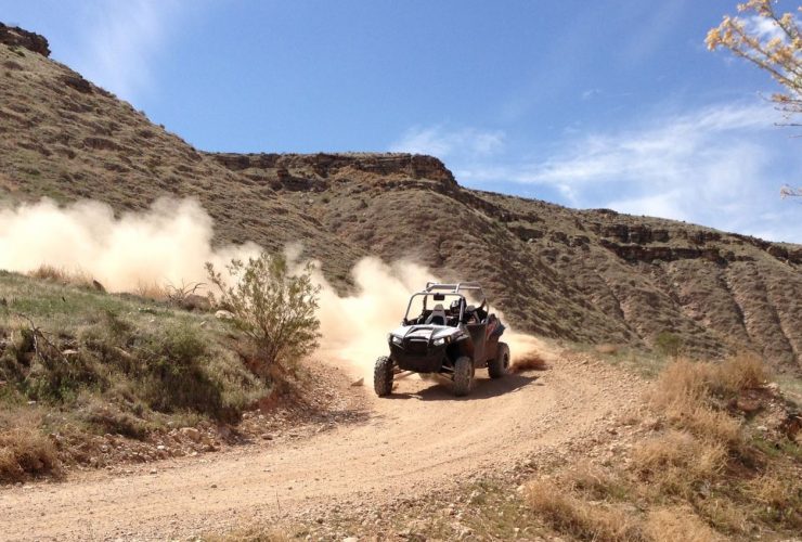 UTV driving fast on dirt road