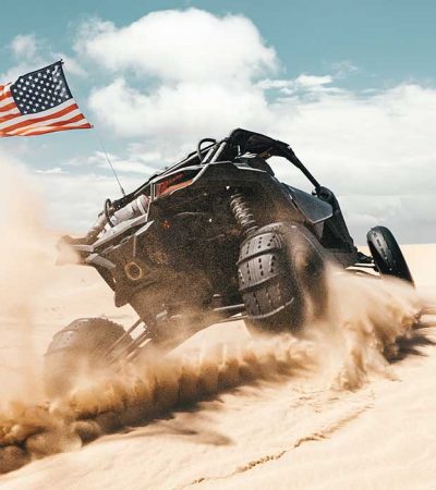 UTV with paddle sand tires and USA flag