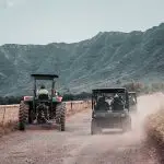 UTVs and tractor on road