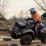 ATV riders on the verge of overturning and having an accident due to a too sharp turn