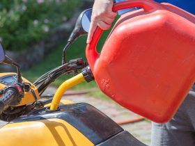 Man refueling ATV with gasoline