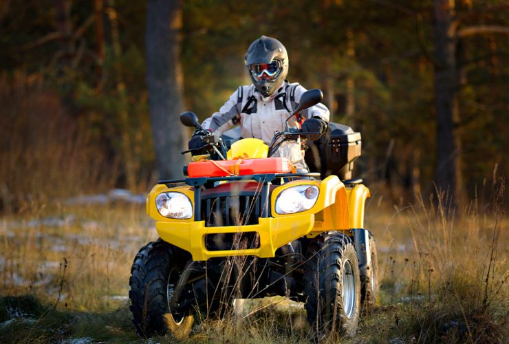 Man driving ATV with power steering offroad