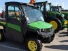 John Deere Gator XUV835M farmer UTV parked next to tractors