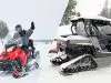 Snowmobile vs UTV with tracks in the snow